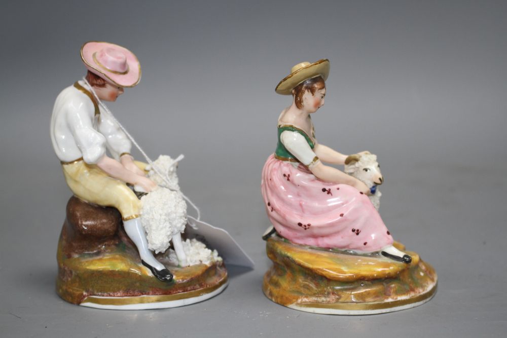 A pair of Staffordshire porcelain groups of a shepherd and shepherdess, c.1830-50, H. 11.5 -12.5cm